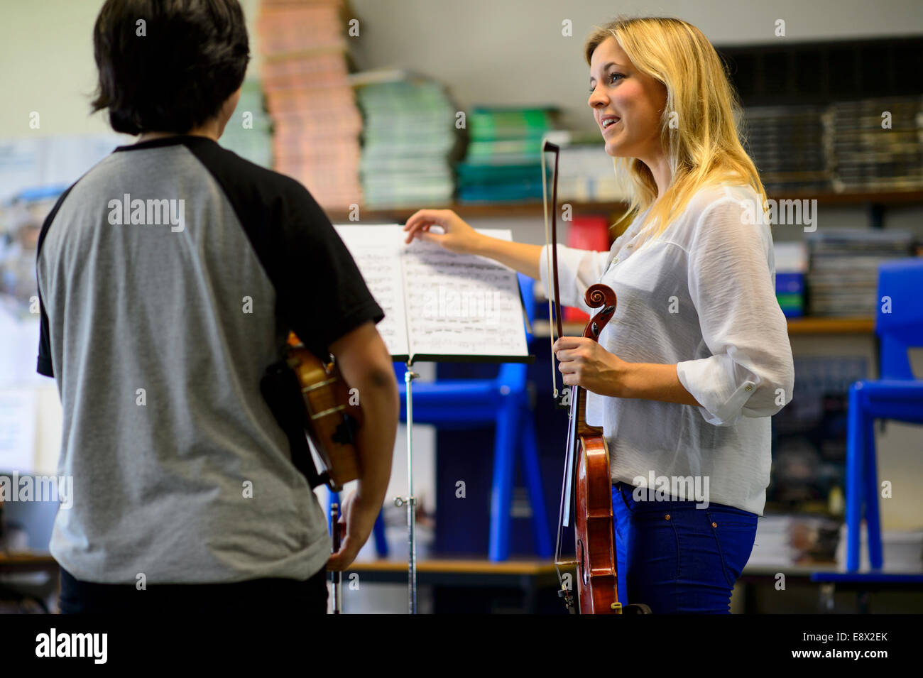 Strings: music education: two Young musicians rehearsing playing violin ...