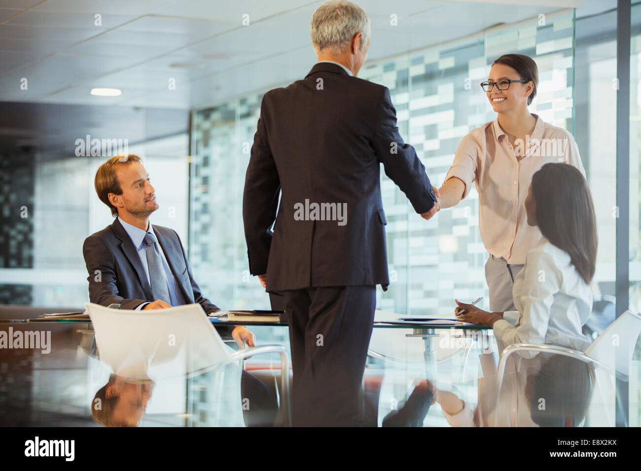Business people shaking hands in office building Stock Photo