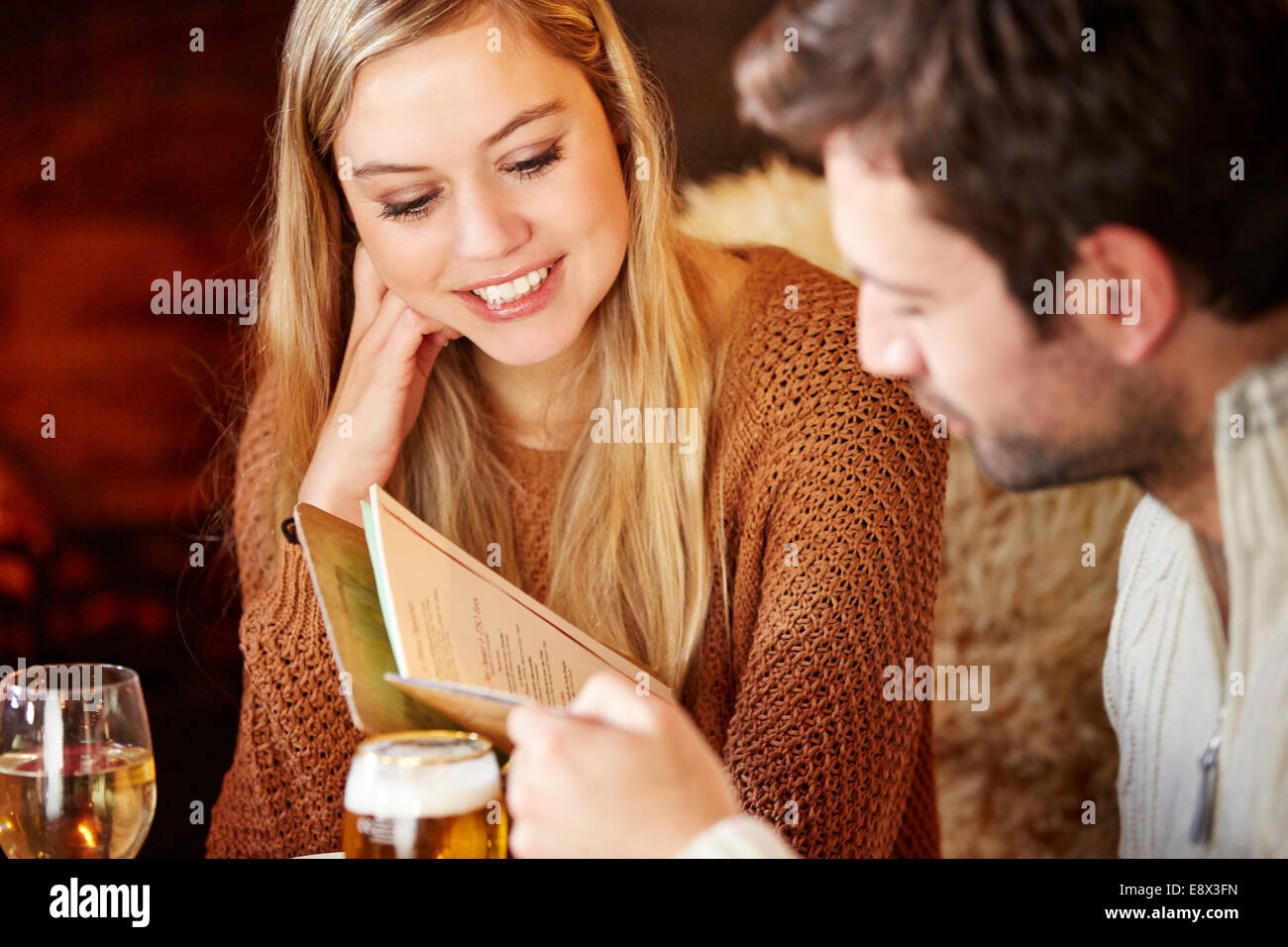 Couple looking at restaurant menu together Stock Photo