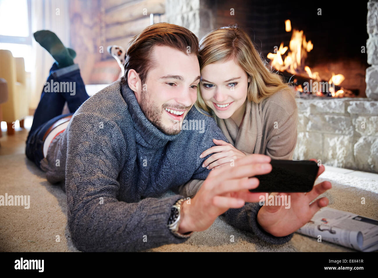 Couple looking at cell phone together Stock Photo