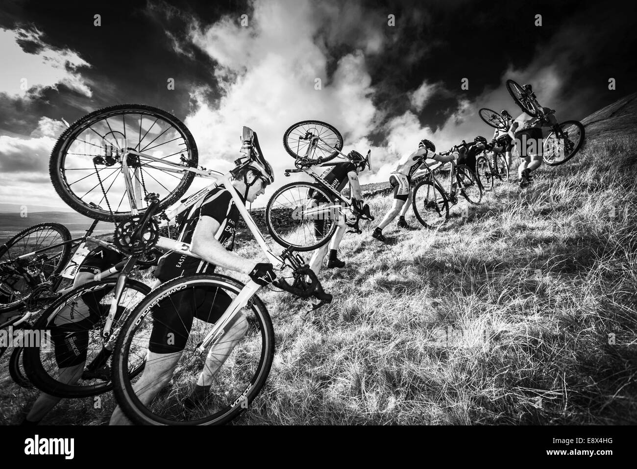 Riders carrying bikes inThree Peaks cyclocross, Simon Fell, Yorkshire Dales, UK Stock Photo