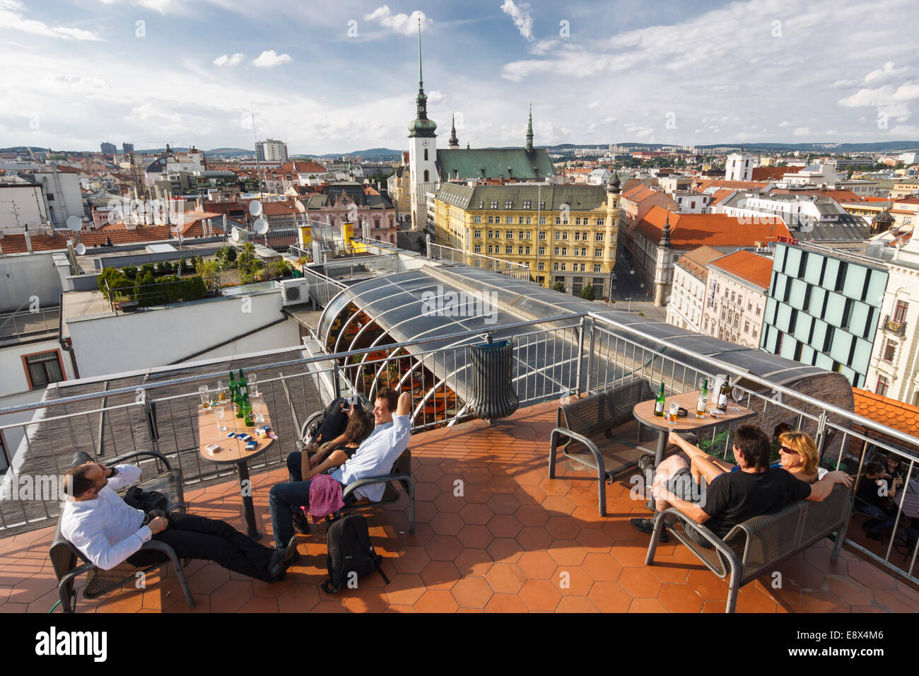 People at a rooftop terrace bar with Brno overview. Stock Photo
