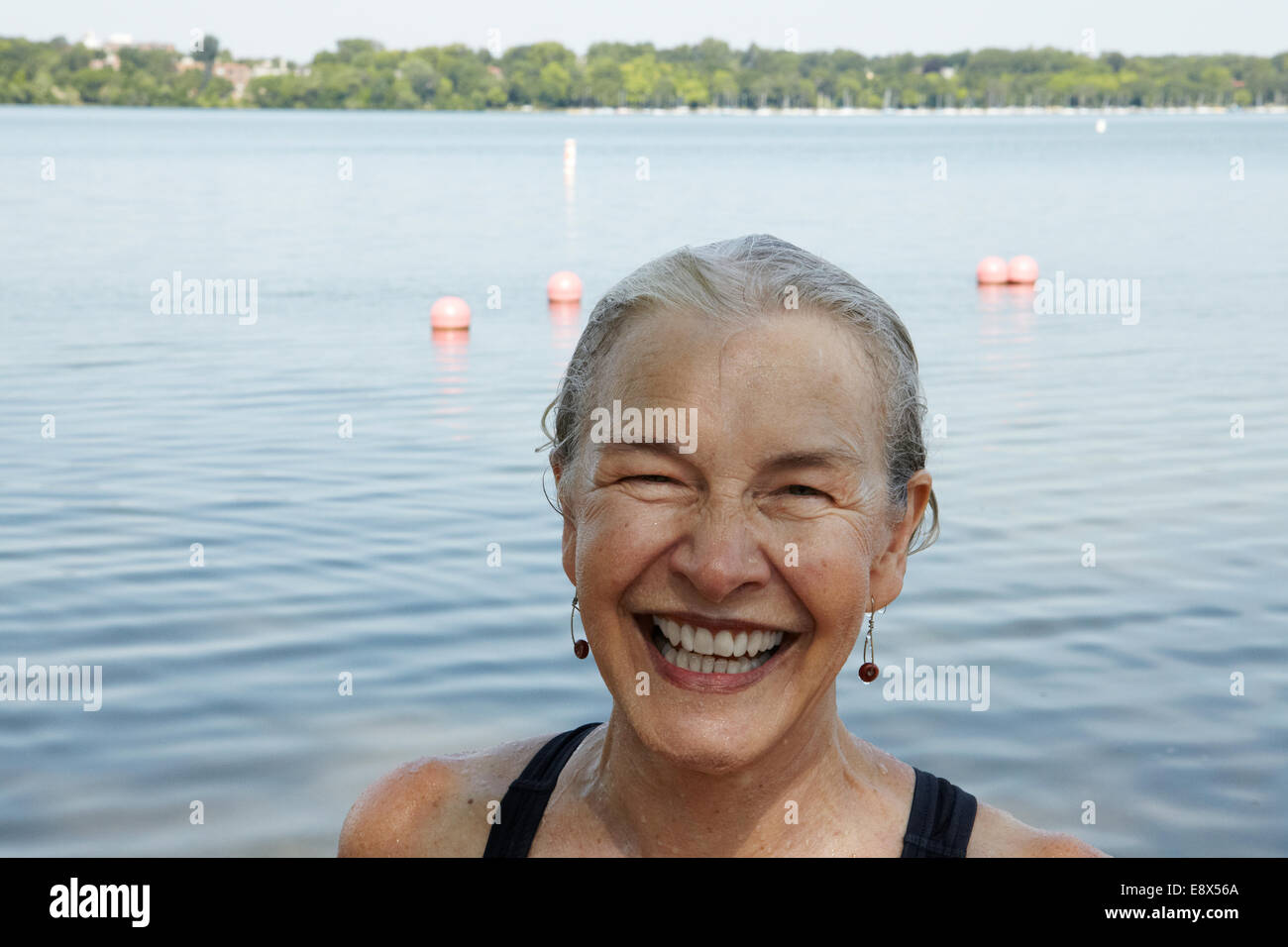 66 year old senior woman swimming in lake Stock Photo