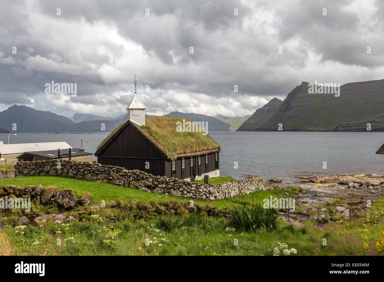 Wooden Church in Funningur with roof turf covered in Streymnes island. Faroe Island Stock Photo