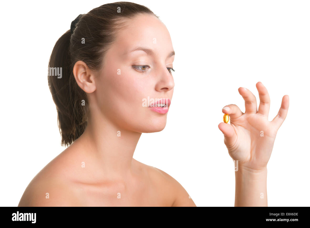 Woman about to take a pill, isolated in white Stock Photo