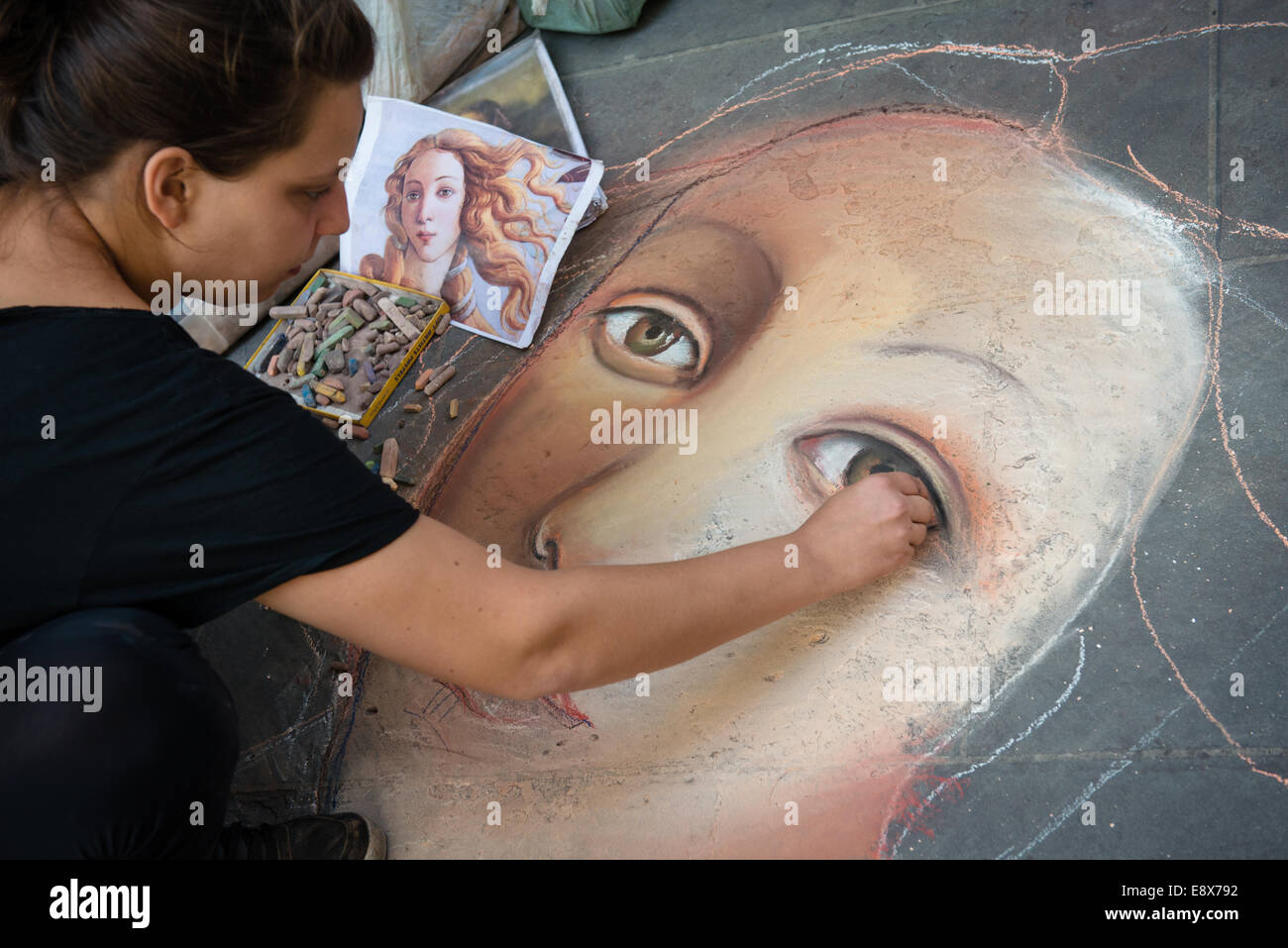 FLORENCE, ITALY - SEPTEMBER 15, 2014: artist painting face of Venus (from Botticelli) on the pavement by chalk, Florence, Italy Stock Photo