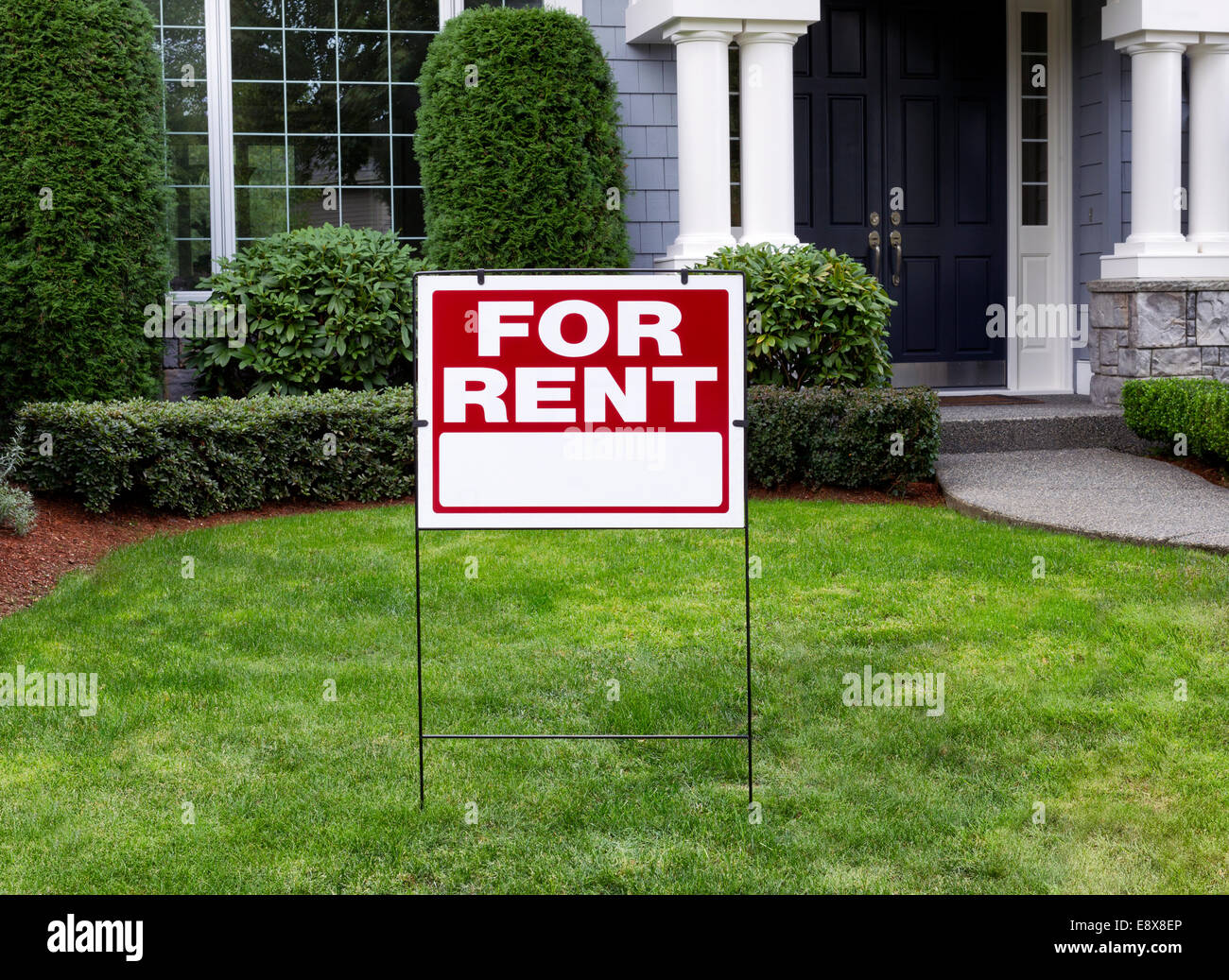 Closeup view of Modern Suburban Home with for Rent Sign in front Yard Stock Photo