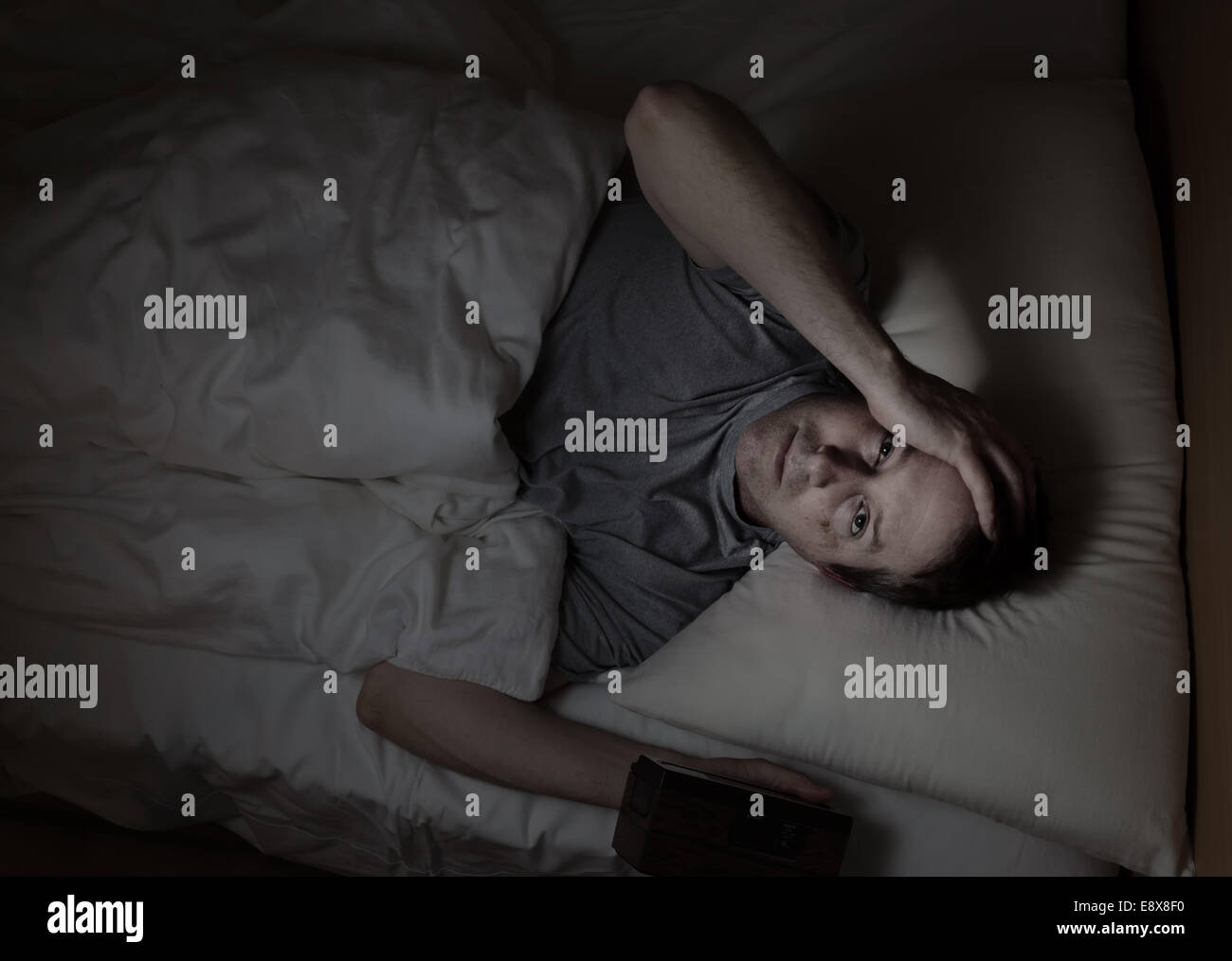 Top view image of mature man, looking forward, having trouble sleeping from insomnia Stock Photo
