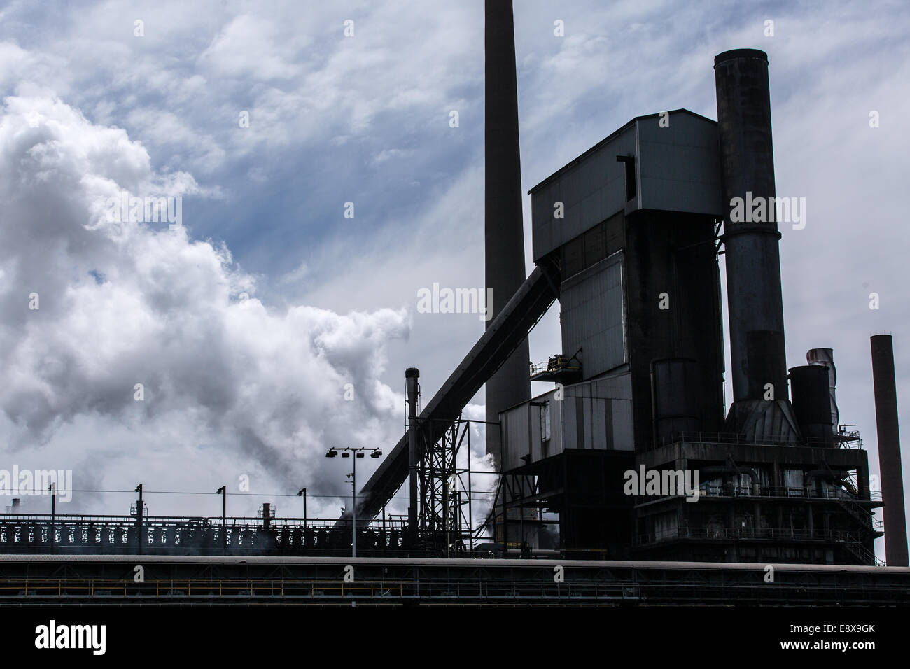 A steel mill in Australia emitting a plume of smoke or steam Stock Photo