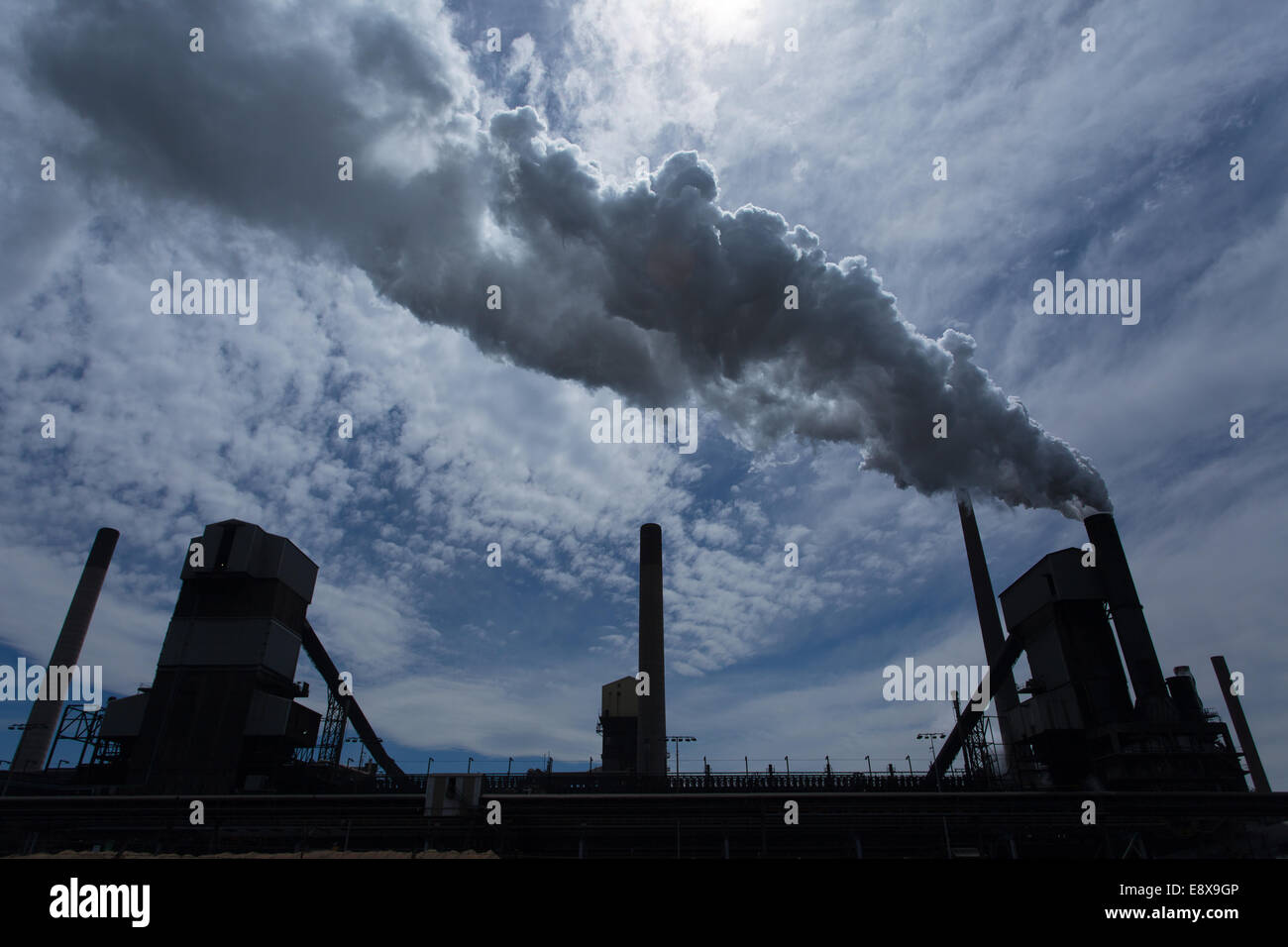 A steel mill in Australia emitting a plume of smoke or steam Stock Photo