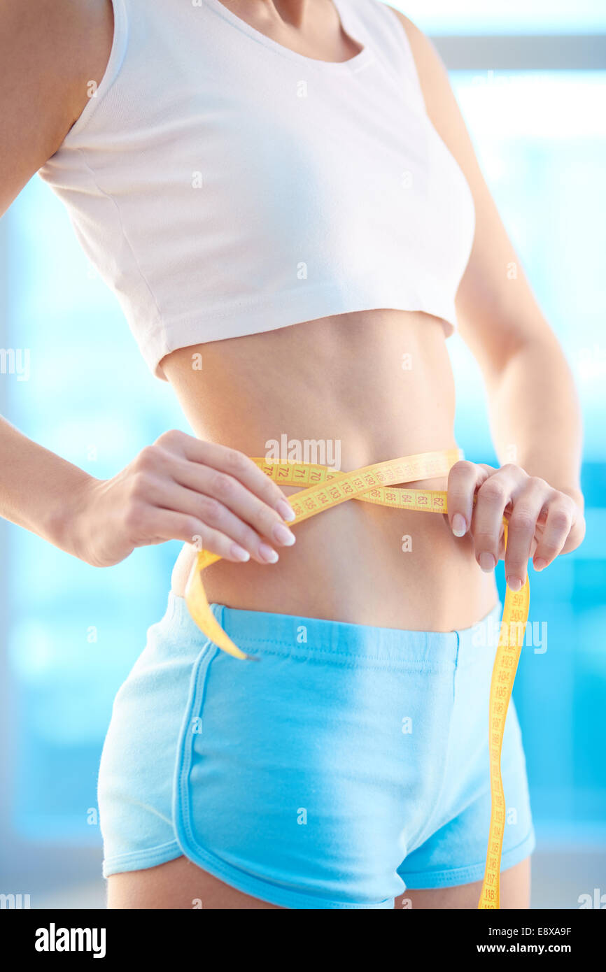  Fit and sporty female measuring her waist Stock Photo - Alamy