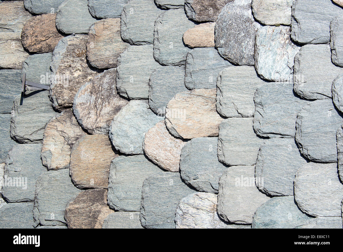Stone tiles of slate-roof rural house as background Stock Photo