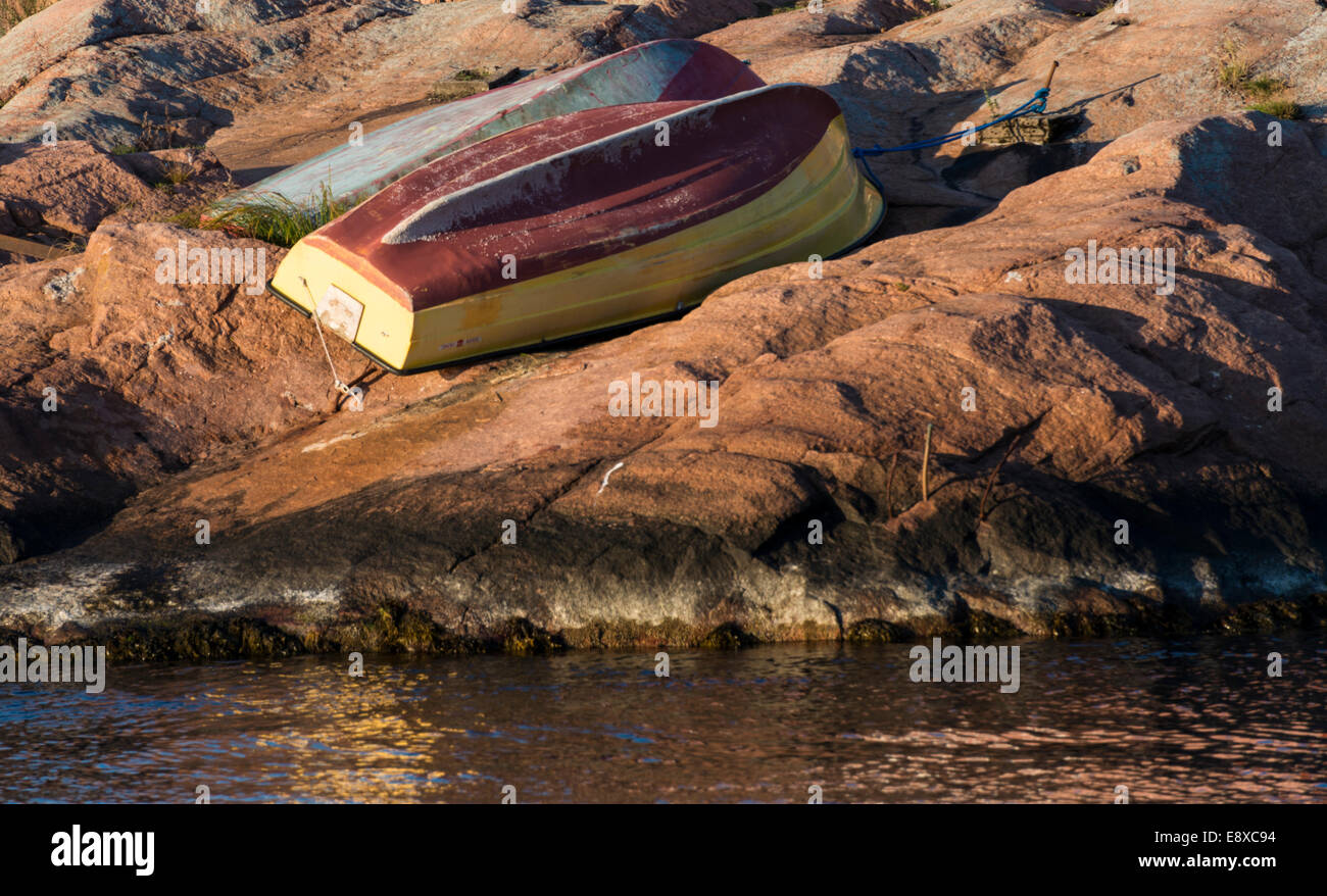 small boats upside down on shore Stock Photo