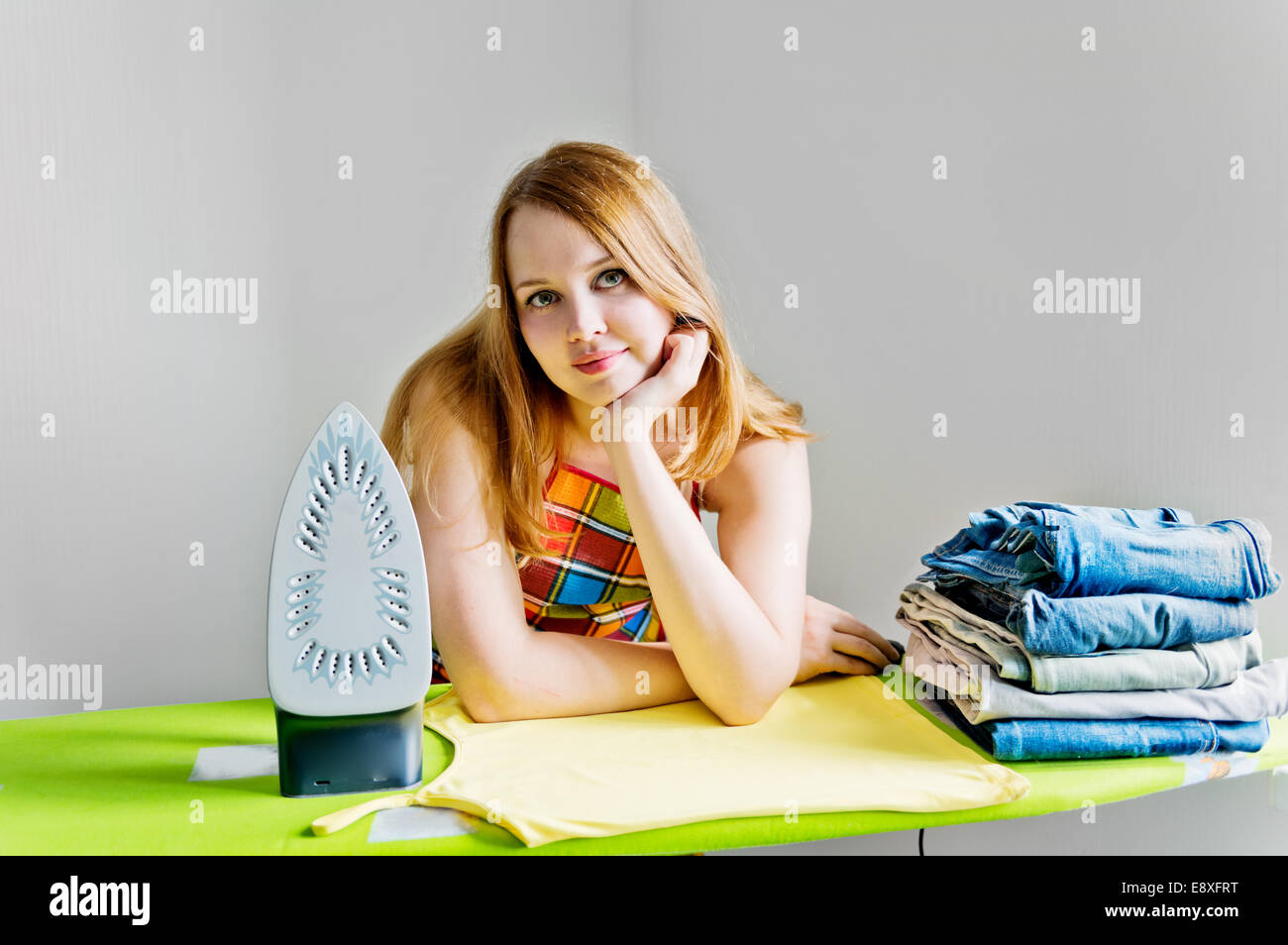 Happy Woman Ironing Cloth With Electric Iron In Kitchen Stock Photo,  Picture and Royalty Free Image. Image 44713856.