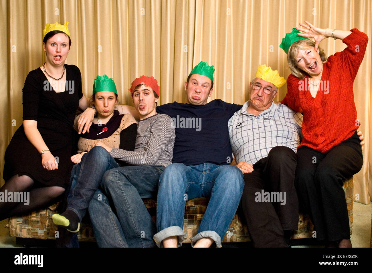 crazy funny family christmas party hat photo with everyone pulling silly faces Stock Photo