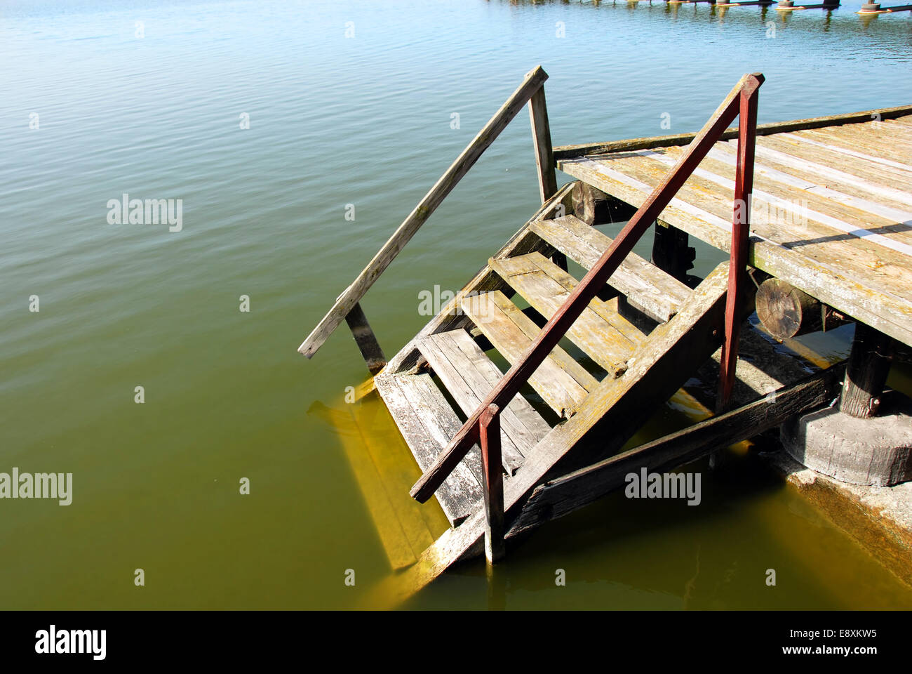 Wooden stairs into water Stock Photo - Alamy