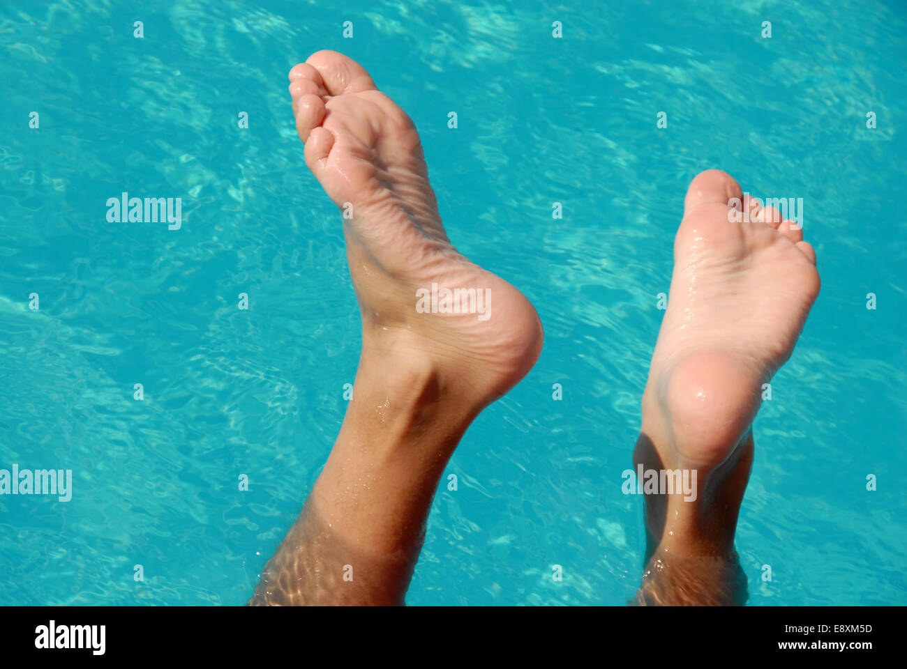 Feet in swimming pool Stock Photo Alamy