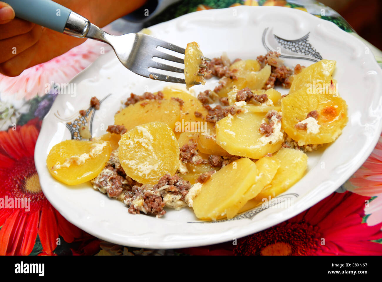 Cooking, heating food in the microwave. Baked potatoes with meat,  vegetables on a white plate in the microwave top view Stock Photo - Alamy