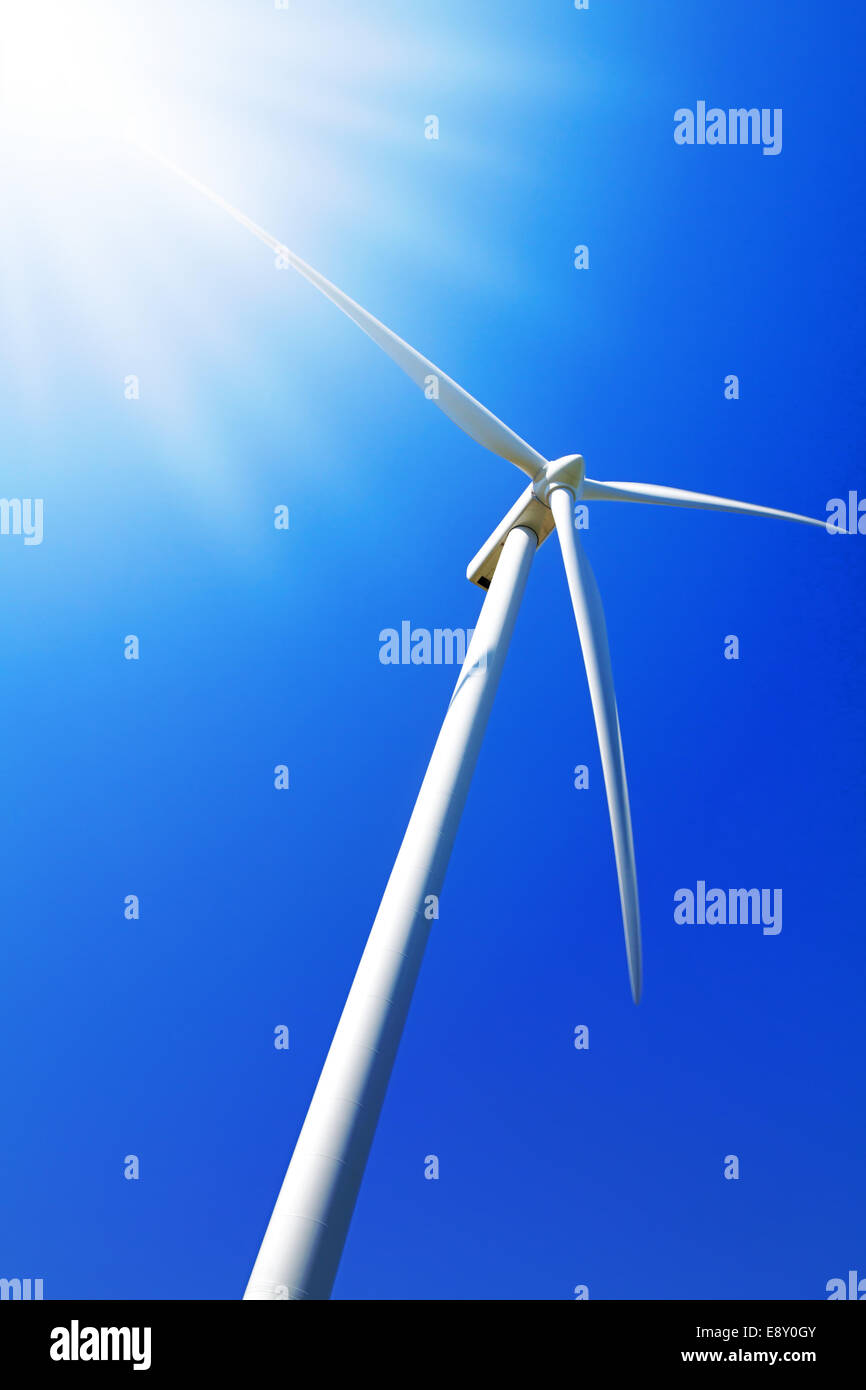 Wind turbine under clear blue sky Stock Photo - Alamy