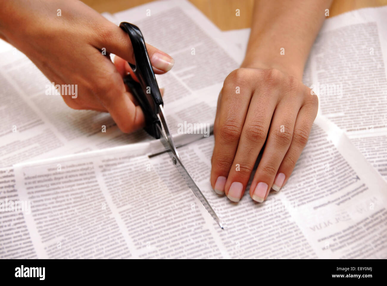Cutting out from newspapers Stock Photo