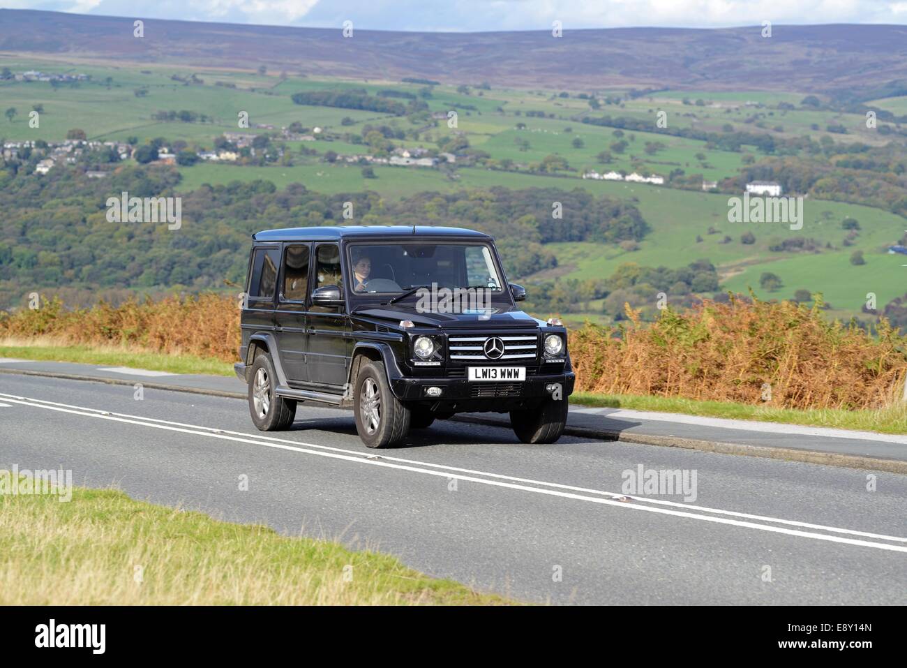 A Mercedes-Benz G Wagen 4x4 driving up a hill on Ilkley Moor, West Yorkshire Stock Photo