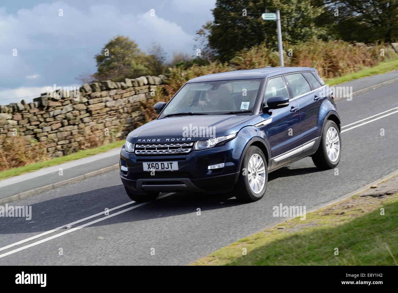 Range Rover Evoque driving down a moorland road in West Yorkshire Stock Photo