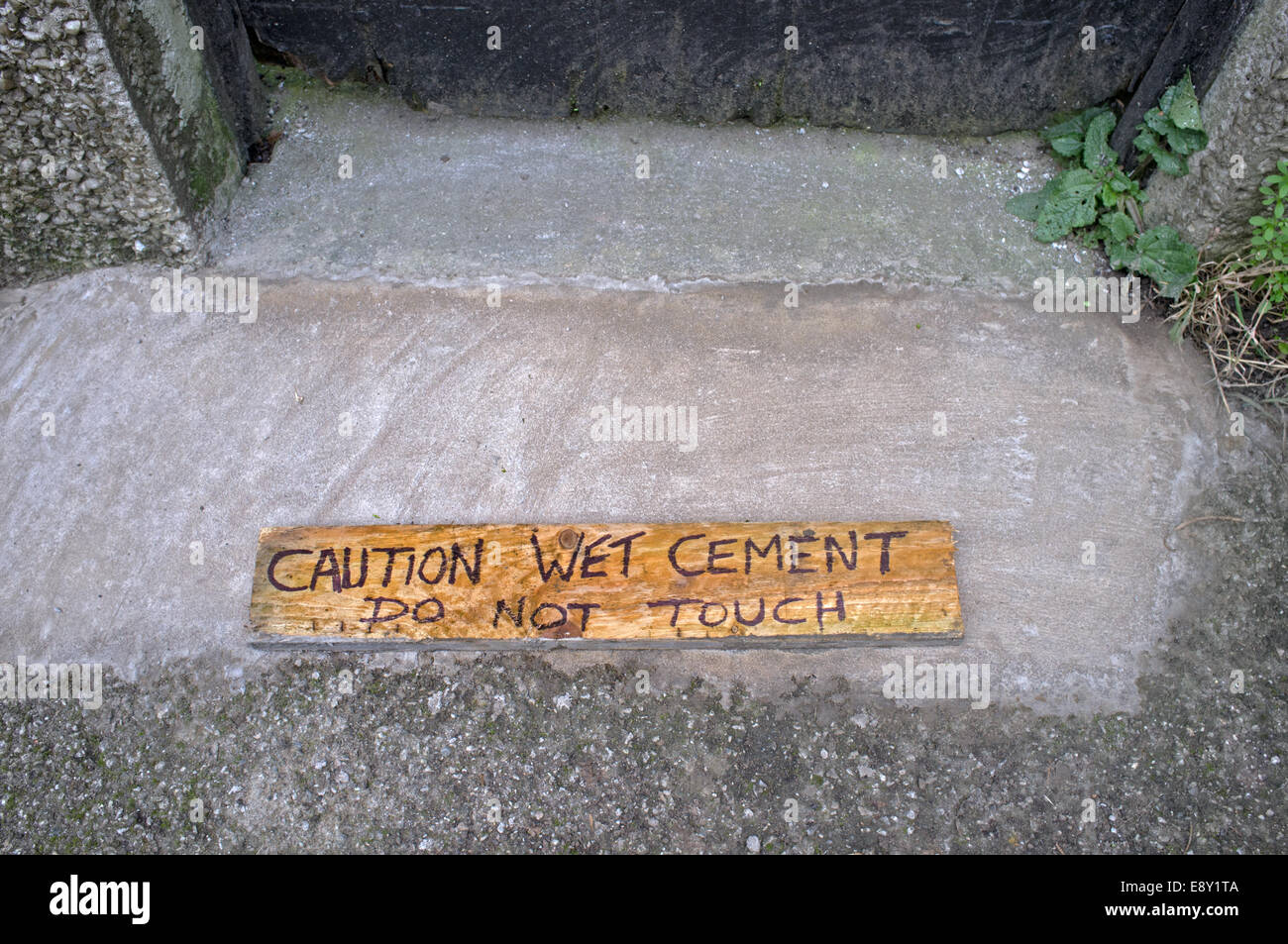 A wooden sign urging caution Stock Photo