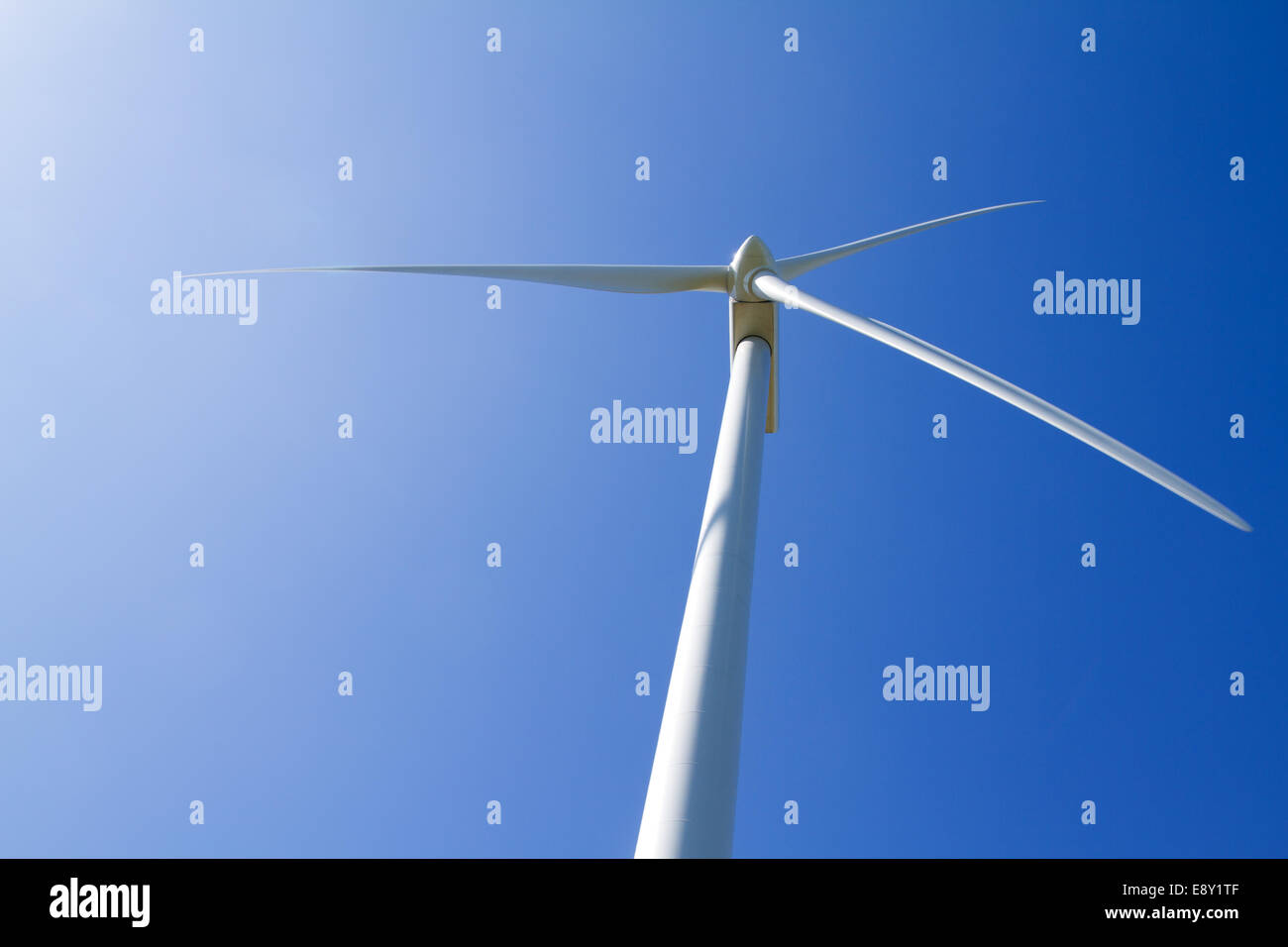 Wind turbine on clear blue sky Stock Photo - Alamy