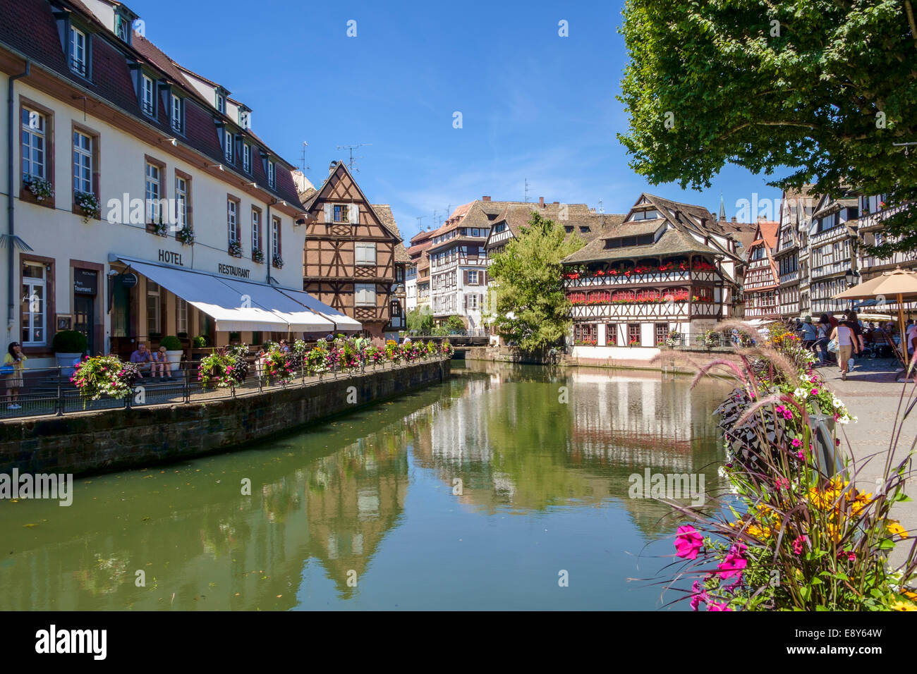 Strasbourg, France - Waterfront in Petite-France old district with medieval buildings and restaurants Stock Photo