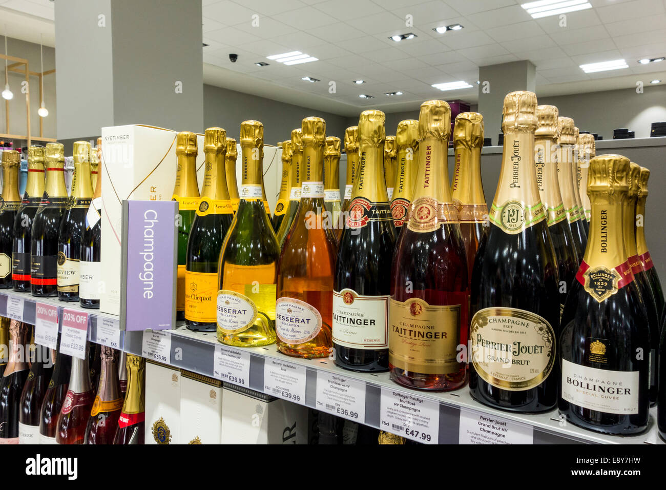 Champagne bottles displayed on a shelf at Waitrose Supermarket, UK