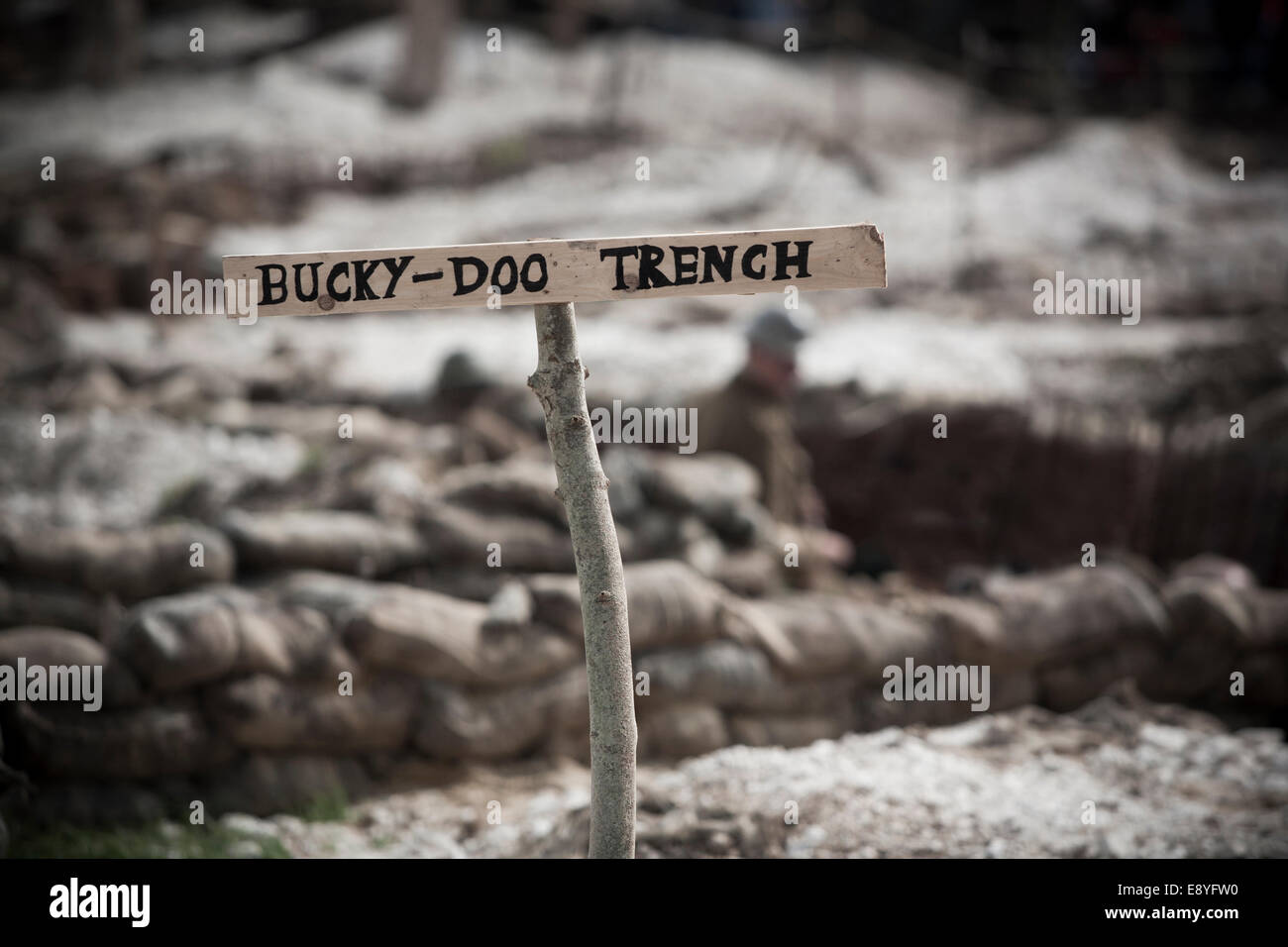 WW1 no mans land recreation, wooden sign for 'Bucky-Doo Trench' in front of sand bags and trenches. Stock Photo