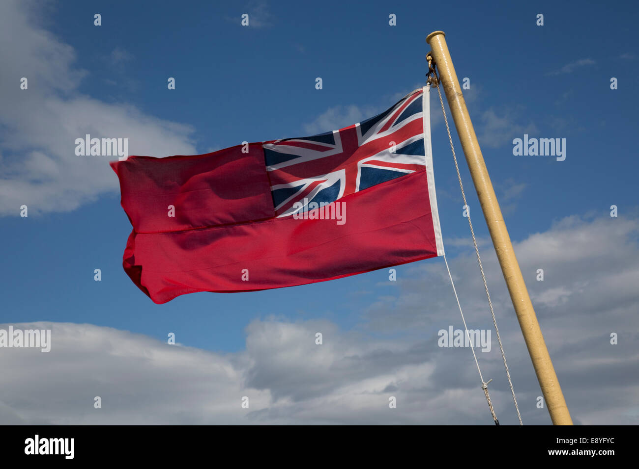 Red Ensign or Red Duster flag flying in breeze on Caledonian McBrayne ferry Barra Outer Hebrides Scotland Stock Photo