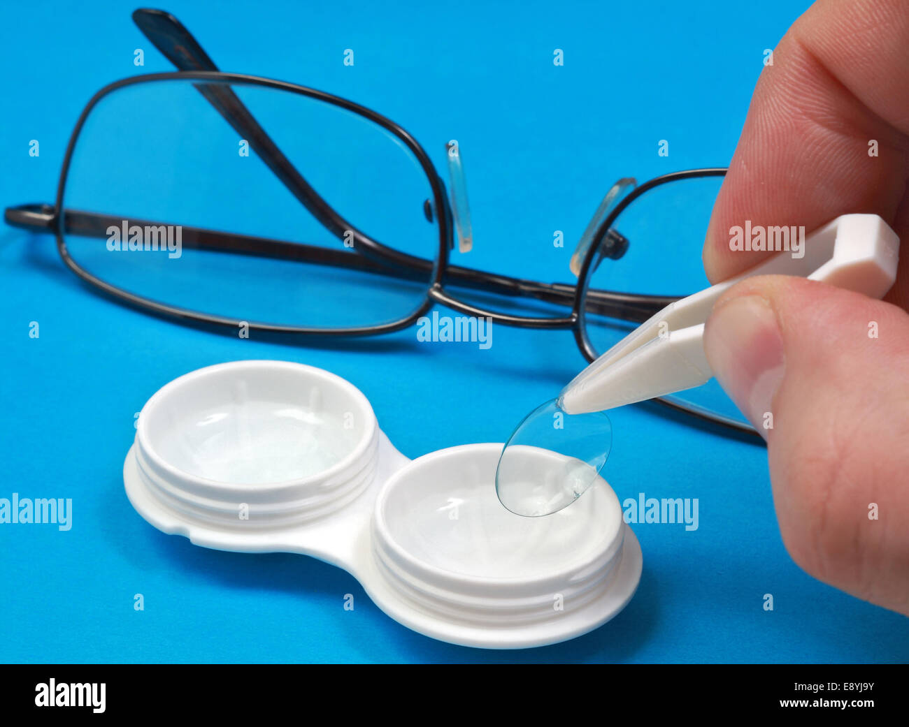 Removing the contact lens from its case Stock Photo