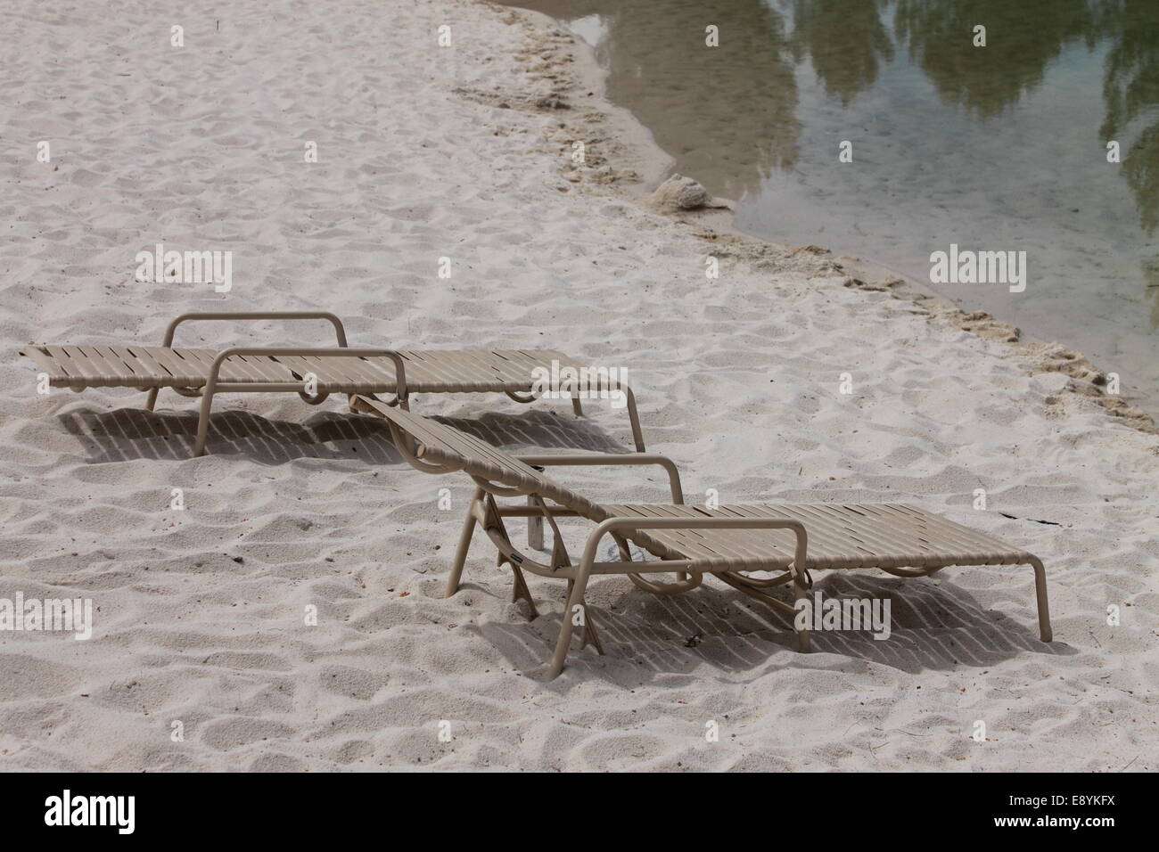 Lounge chairs on an isolated beach Stock Photo