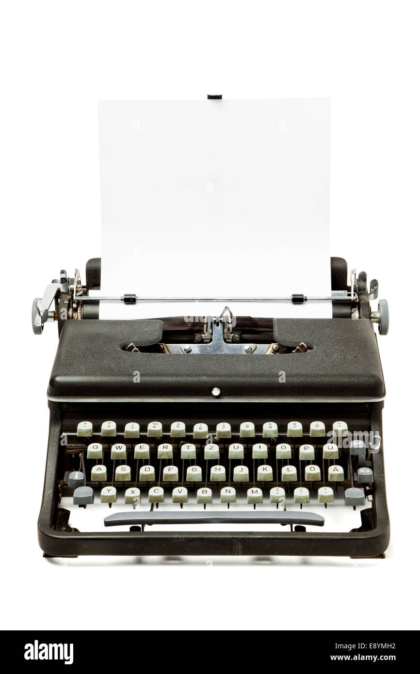 View of a vintage typewriter with a blank paper. Stock Photo by