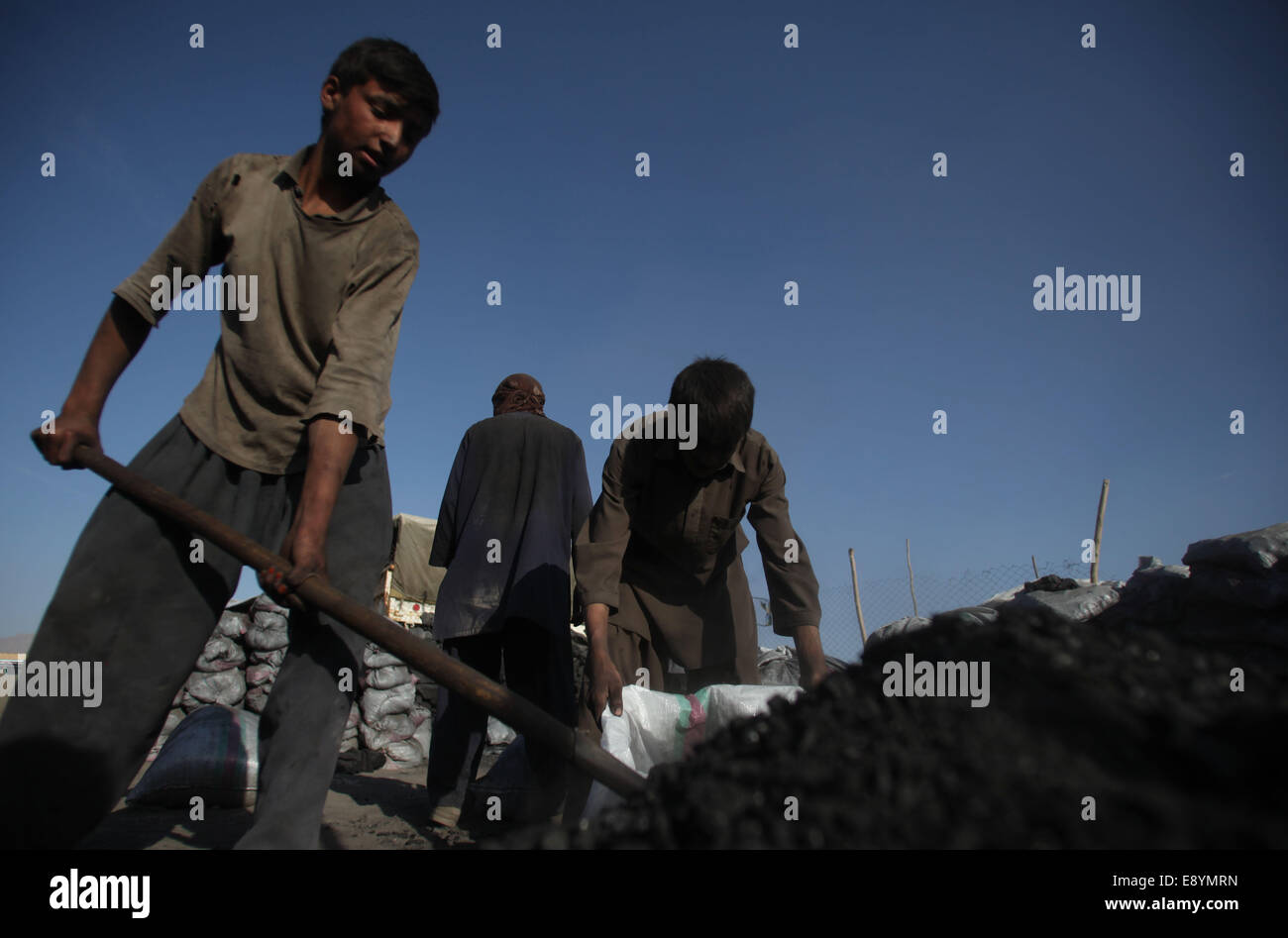Kabul, Afghanistan. 16th Oct, 2014. Laboers work at a coal market in Kabul, Afghanistan, Oct. 16, 2014. Afghan people are preparing fuel for the upcoming winter. © Ahmad Massoud/Xinhua/Alamy Live News Stock Photo