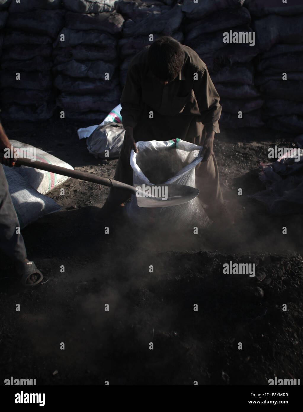 Kabul, Afghanistan. 16th Oct, 2014. Laborers work at a coal market in Kabul, Afghanistan, Oct. 16, 2014. Afghan people are preparing fuel for the upcoming winter. © Ahmad Massoud/Xinhua/Alamy Live News Stock Photo