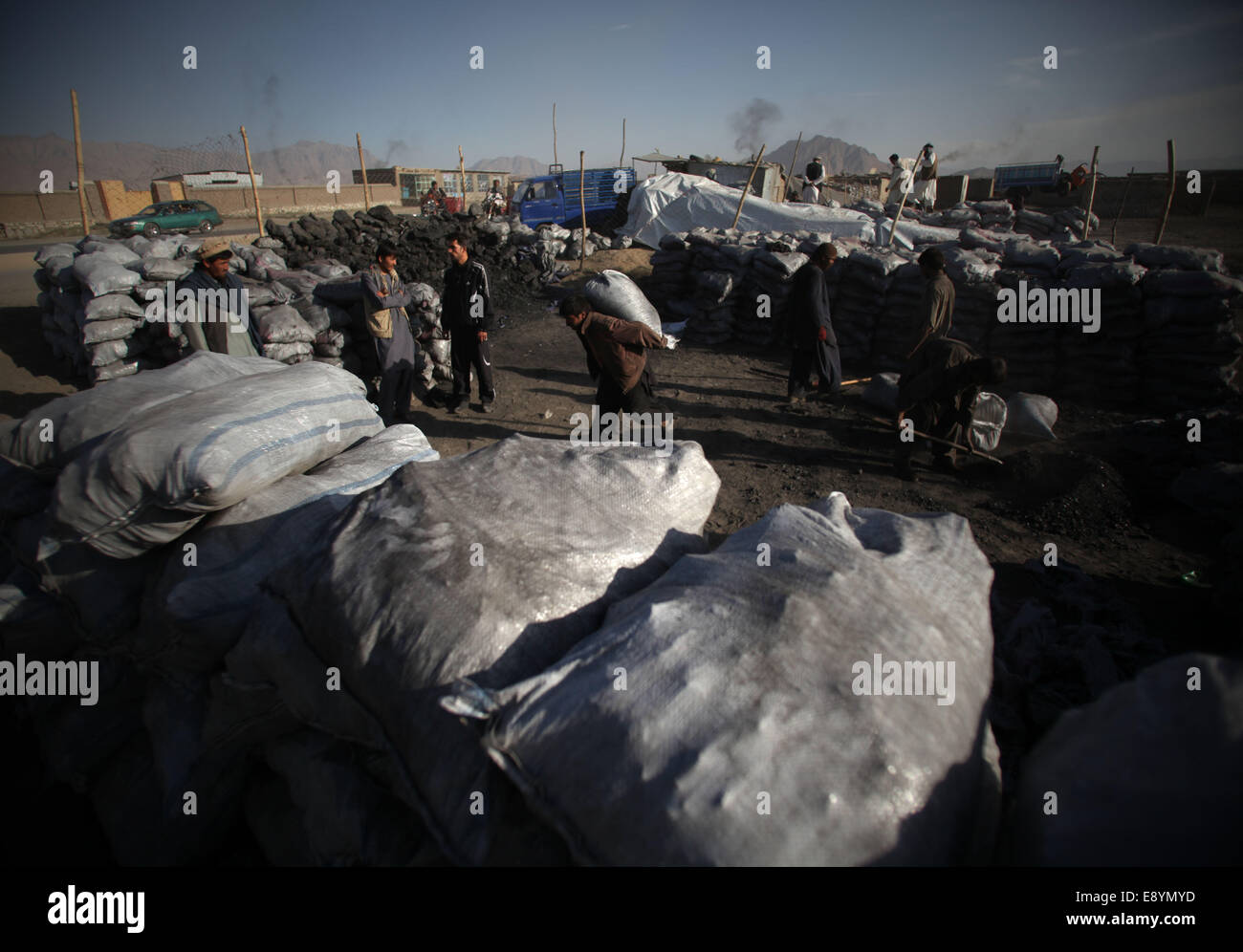 Kabul, Afghanistan. 16th Oct, 2014. Laboers work at a coal market in Kabul, Afghanistan, Oct. 16, 2014. Afghan people are preparing fuel for the upcoming winter. © Ahmad Massoud/Xinhua/Alamy Live News Stock Photo