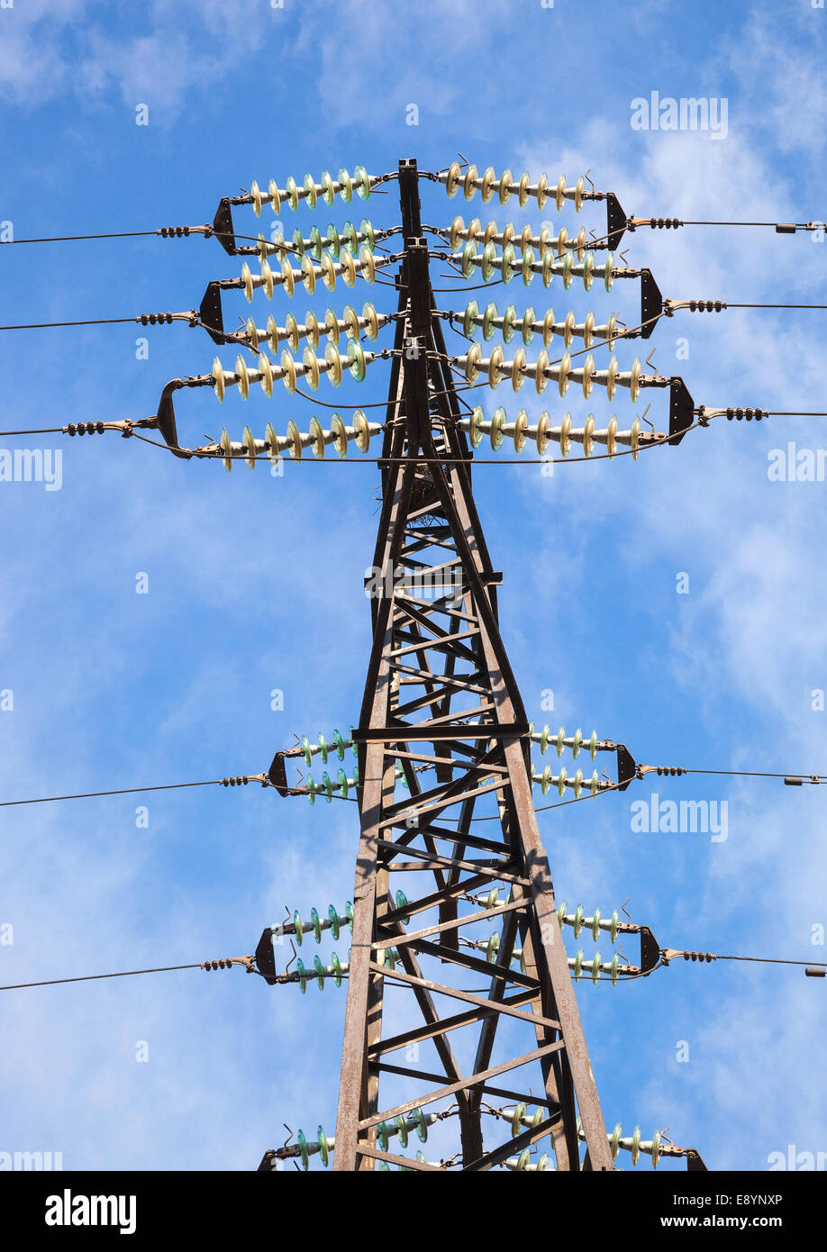High voltage electric tower against blue sky Stock Photo - Alamy