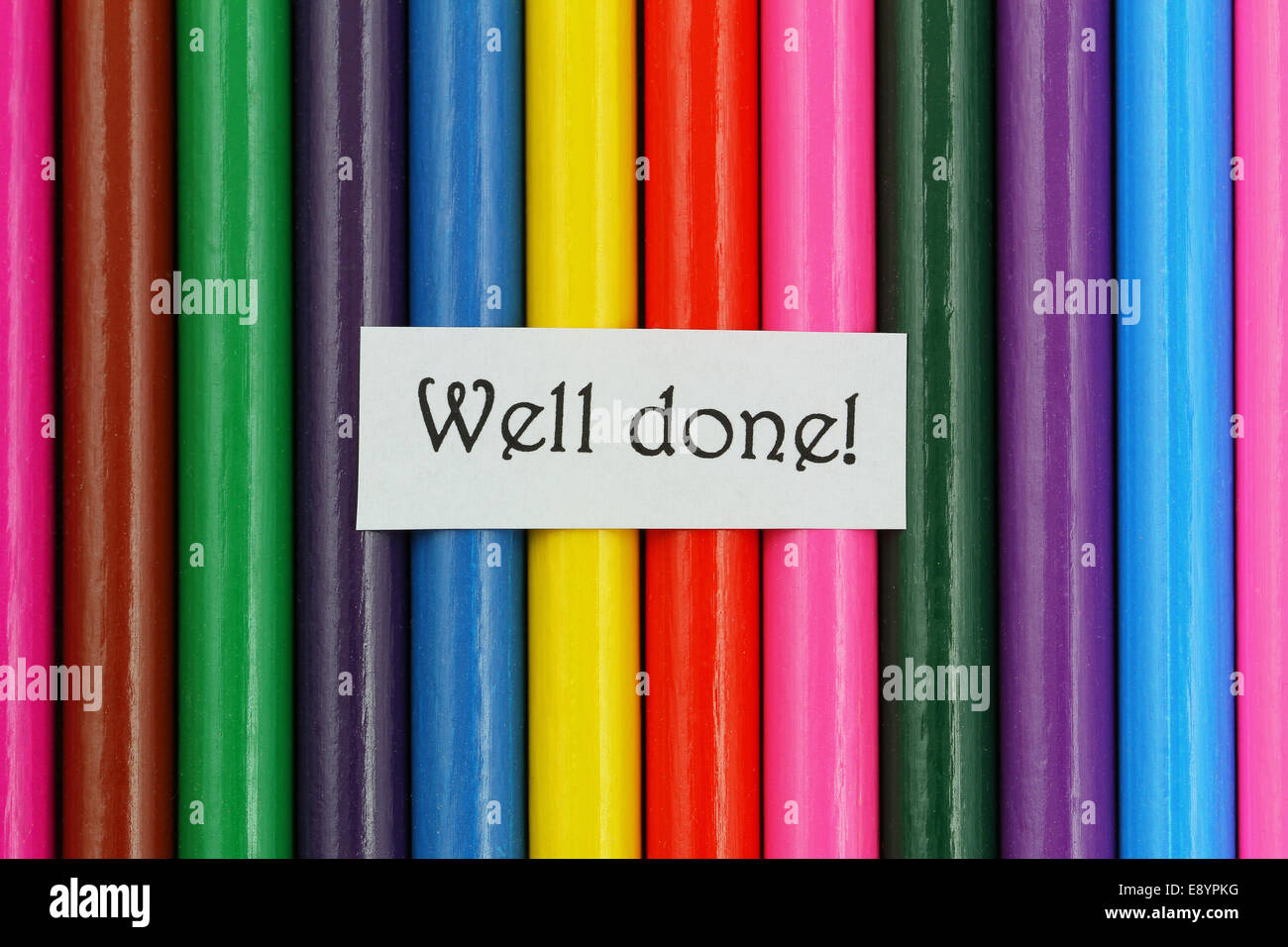 Well done card on background made of colorful pencils Stock Photo