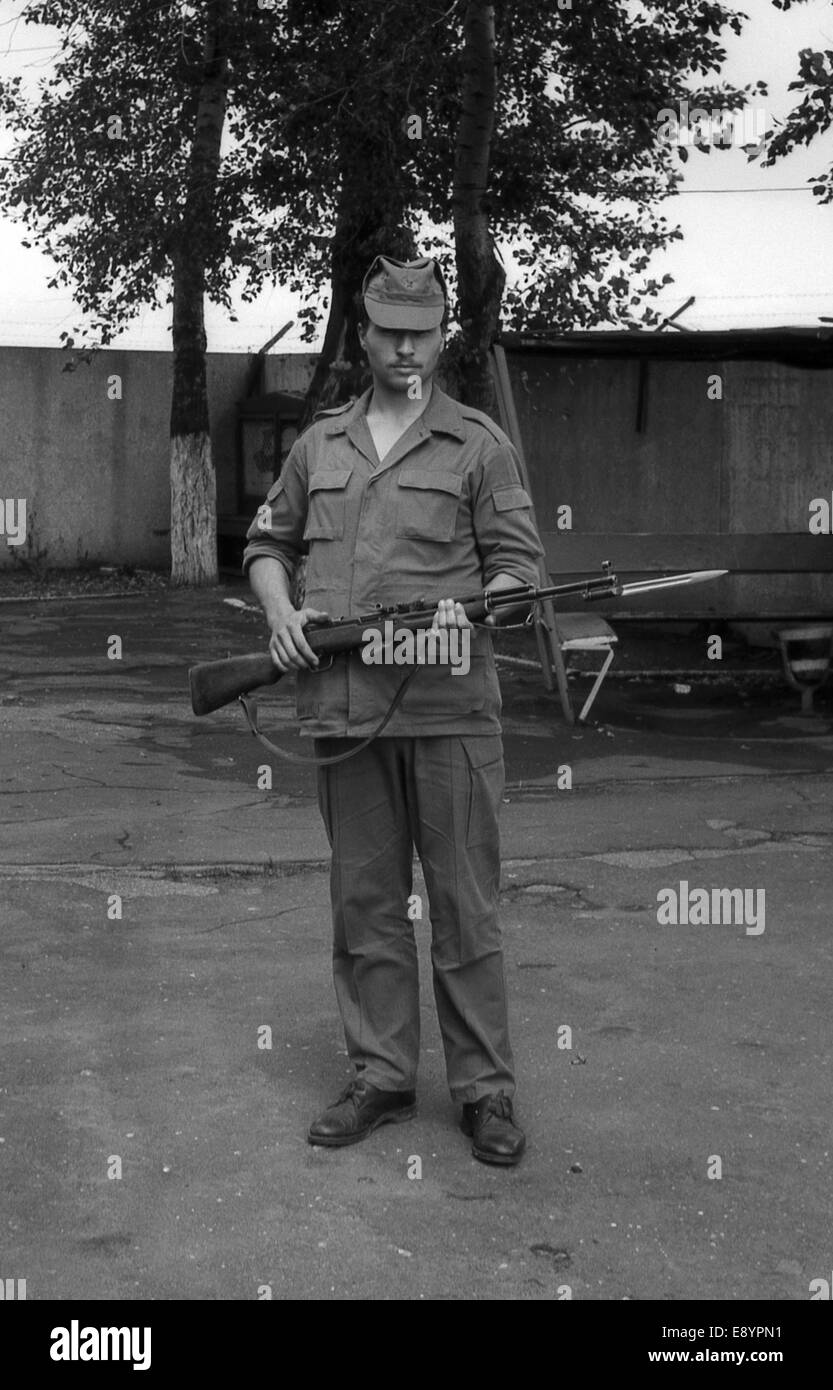 MOSCOW REGION, RUSSIA - CIRCA 1993: A soldier posing with guns. Film ...