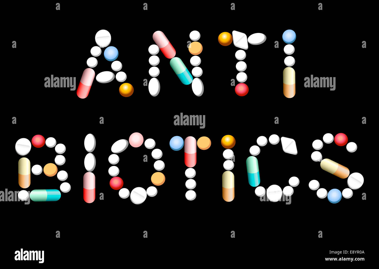 The word ANTIBIOTICS composed with different pills and capsules. Stock Photo