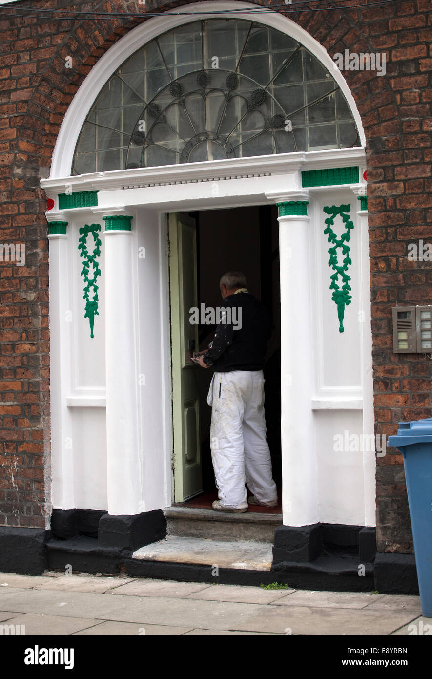 Painter and Decorator painting exterior of Liverpool property