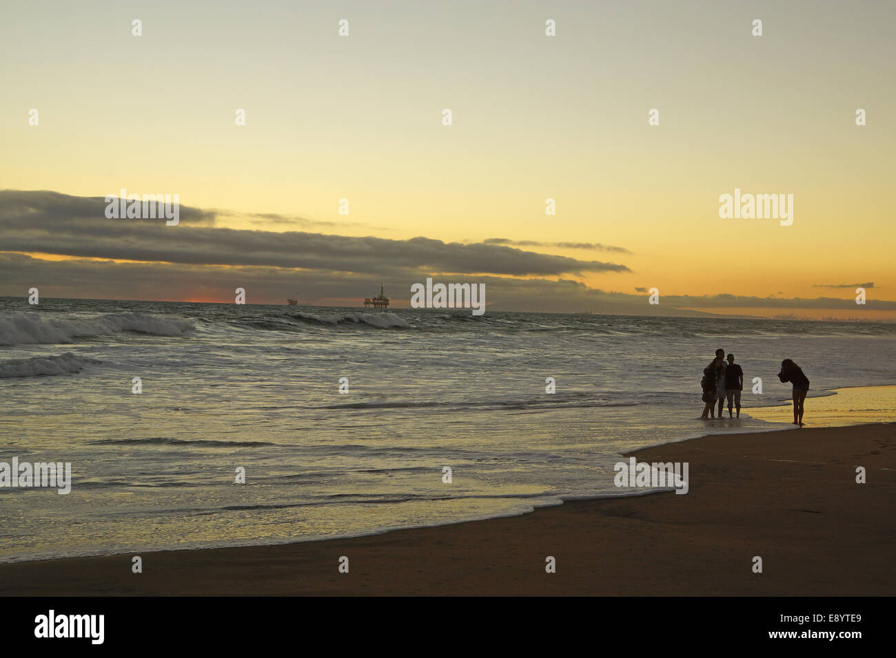 Beach silhouettes at sunset Stock Photo - Alamy