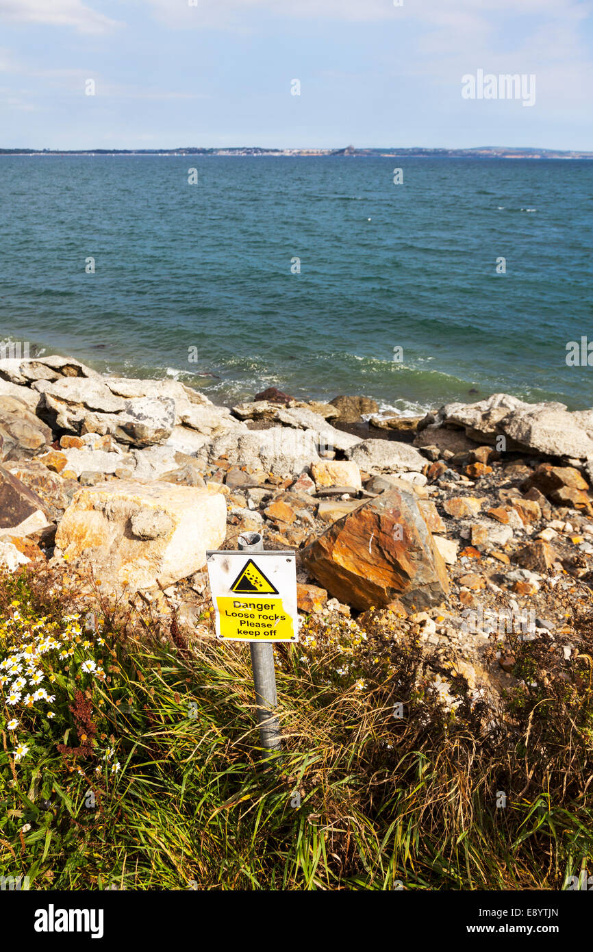 Danger loose rocks falling rock area sign on verge in Newlyn Cornwall UK England Stock Photo