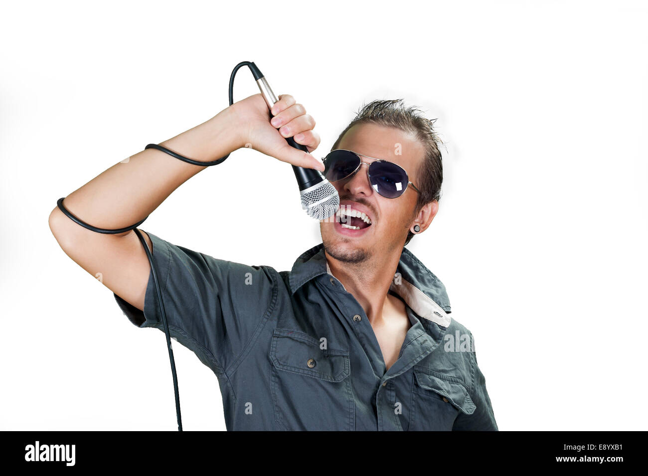 Young european rock singer wearing sunglasses on the white background Stock Photo