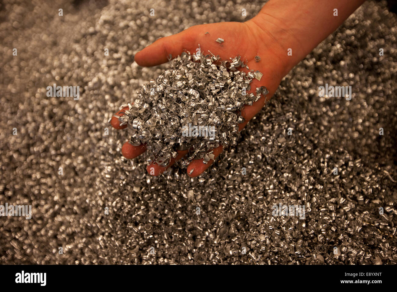 A hand that takes up metal shavings Stock Photo