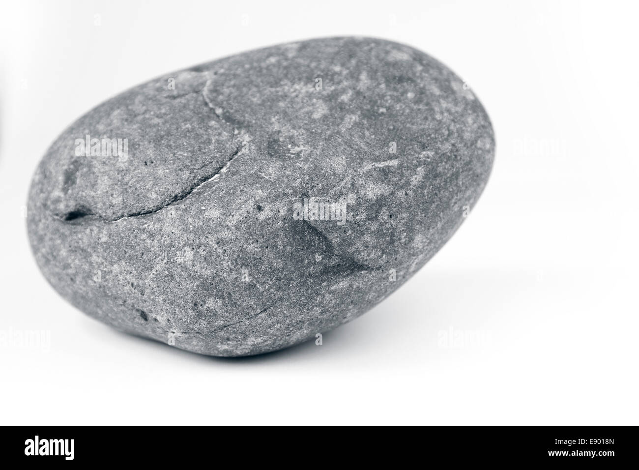 Closeup of one rock on plain background Stock Photo