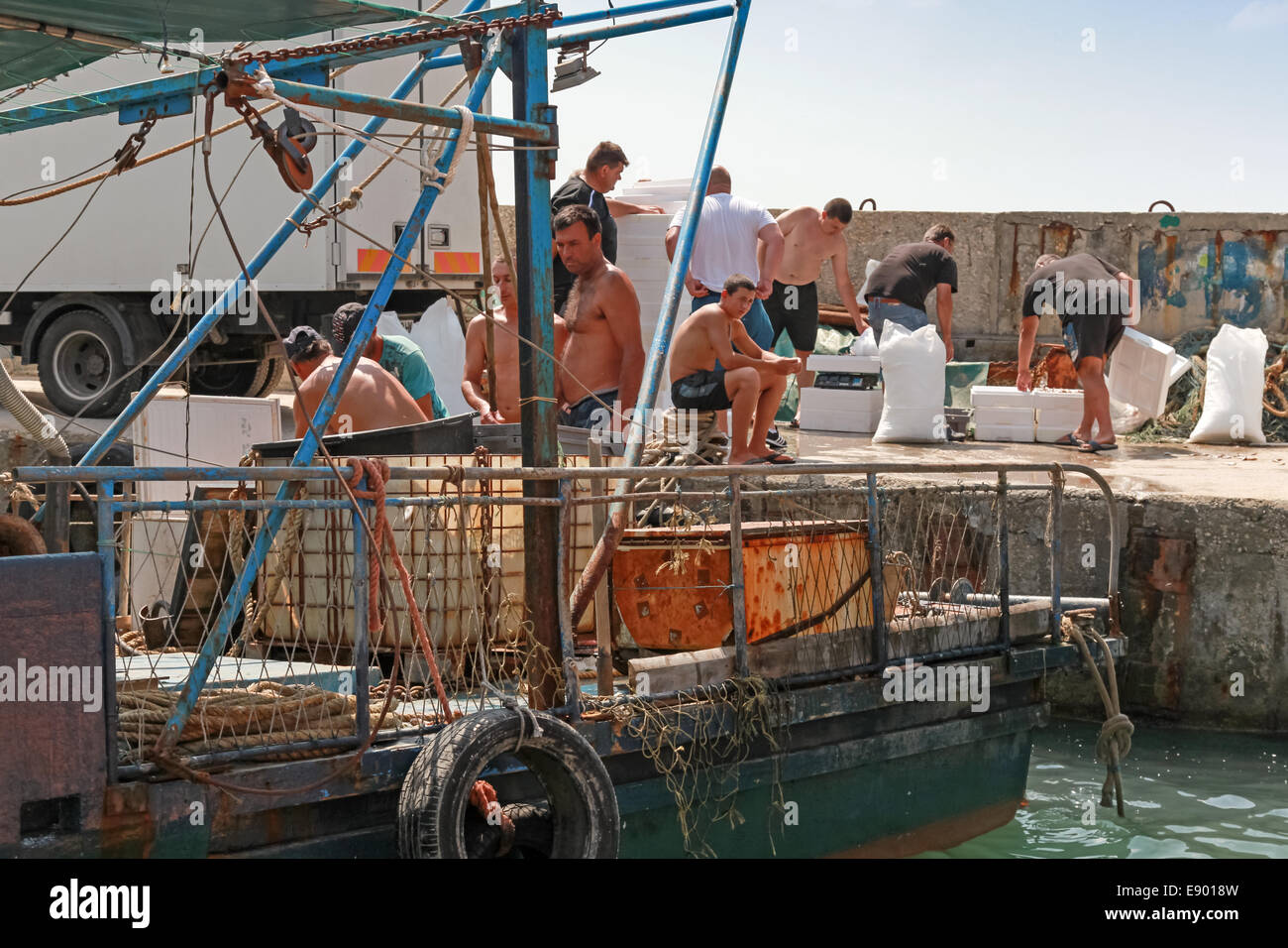 KAVARNA, BULGARIA - JULY 18, 2014: Small fishing boats and fishermen on the coast Stock Photo