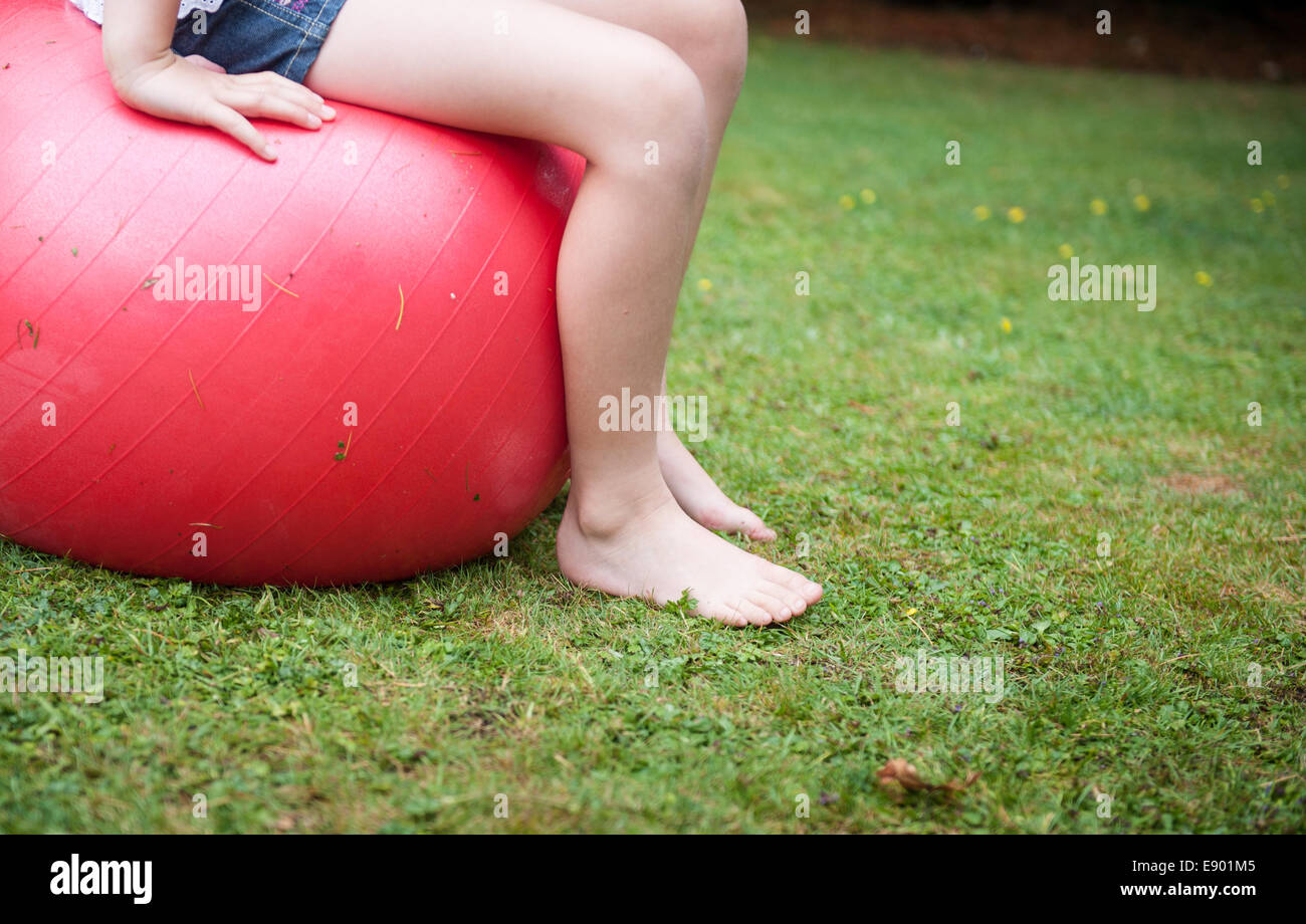 Child on a space hopper in a garden Stock Photo